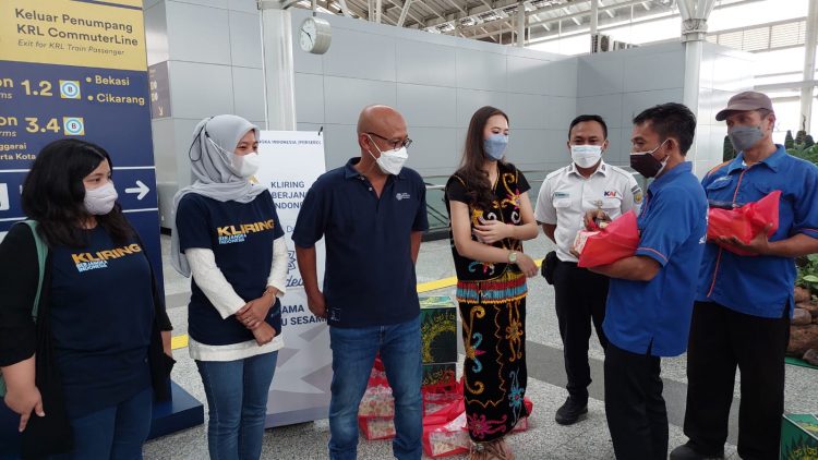 Tampak Fajar Wibhiyadi selaku Direktur Utama PT Kliring Berjangka Indonesia (ketiga dari kiri), Fuji Dwi Nurfitri Ketua Arkadewi KBI (kedua dari kiri) tengah menyampaikan paket bantuan kepada para porter di stasiun Jatinegara.
