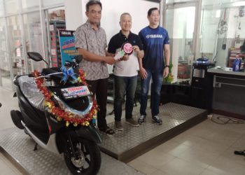 Suratno (kiri) menerima hadiah diserahkan Fitri Agustadhi didampingi Dano. (Foto : Rolan - sinarjambi.com)