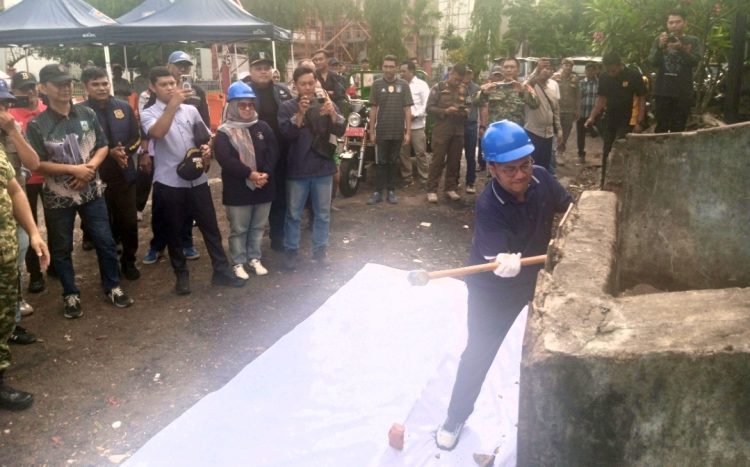 Walikota Jambi Maulana secara simbolis menghancurkan tempat pembuangan sampah di RT 10, pasar buah Kelurahan Orang Kayo Hitam, Kecamatan Pasar, kota Jambi. (Foto : Rolan - sinarjambi.com)